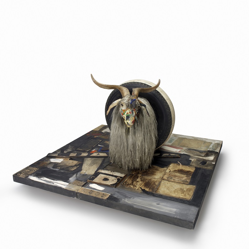Monogram, 1955-59, Combine: oil, paper, fabric, printed reproductions, metal, wood, rubber shoe-heel, and tennis ball on  two conjoined canvases with oil on taxidermied Angora goat with brass plaque and rubber tire on  wood platform mounted on four casters, Moderna Museet, Stockholm. Purchase with contribution from Moderna Museets Vänner/The Friends  of Moderna Museet © Robert Rauschenberg Foundation, New York 