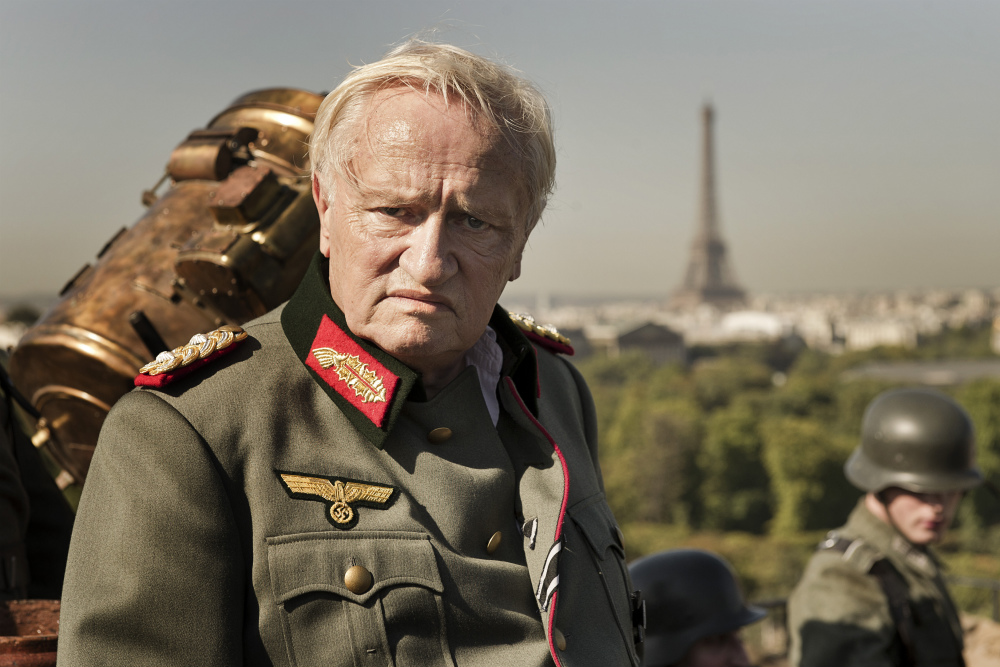 Arestrup as General Choltitz just before the German surrender at the end of the film (with the Eiffel Tower in the distance)
