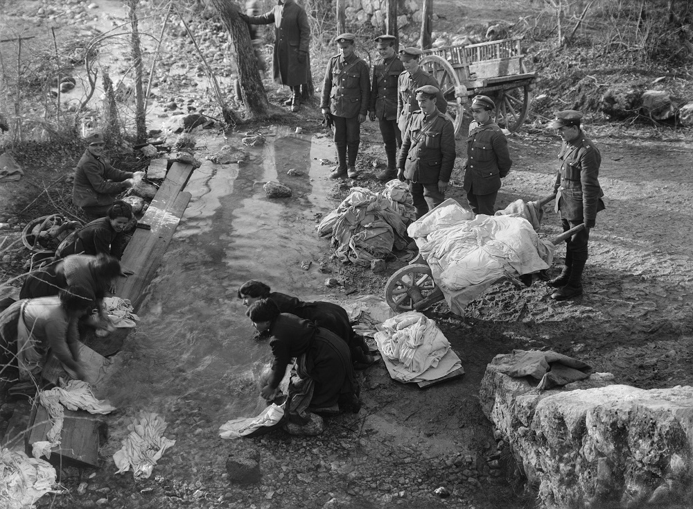 Ernest Brooks, Men of the Royal Engineers watch as their clothes are washed in a stream by Italian peasant women, Novemmer-December 1917, courtesy: Imperal War Museum