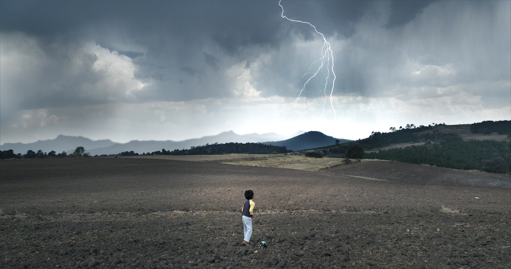 Tono watches the lightning as the rains come again