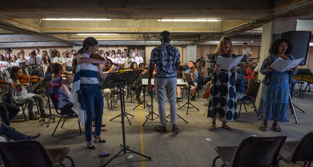 Multi-Story Orchestra, soloists and choirs in 'Verified'