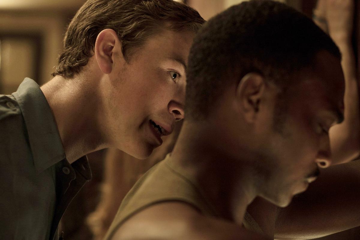 Philip Krauss (Will Poulter) violently interrogates Greene (Anthony Mackie)