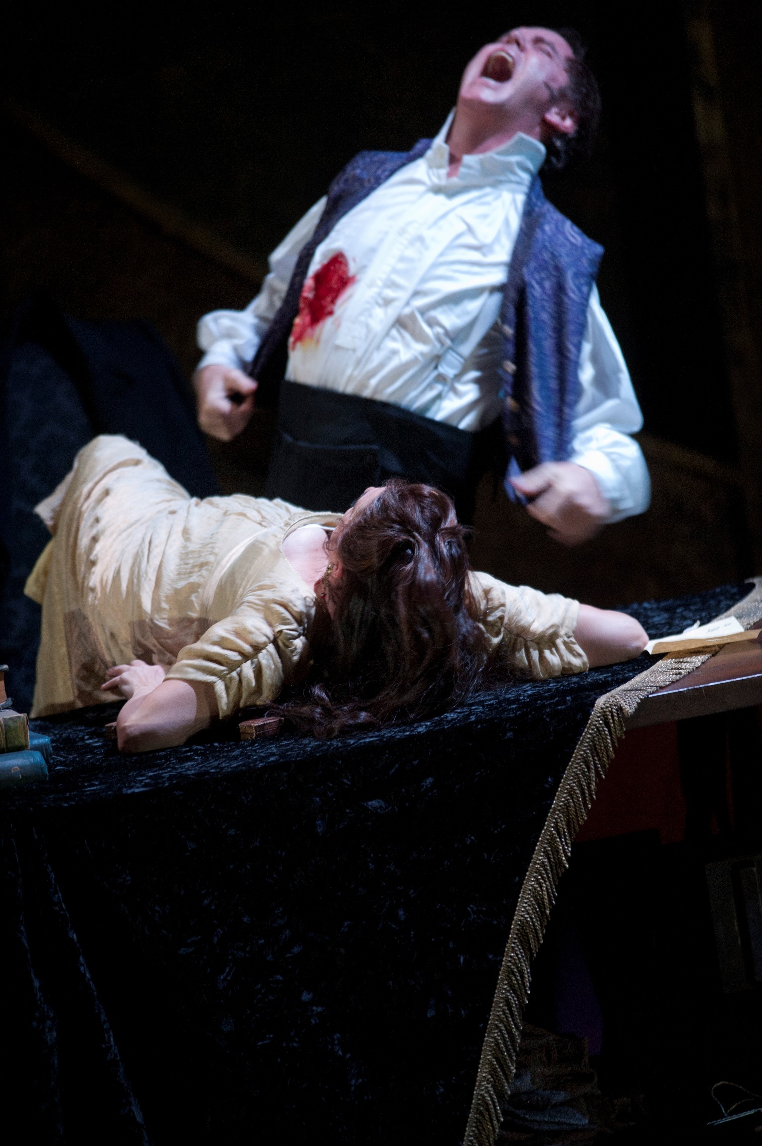 Anthony Michaels-Moore's Scarpia reels from the fatal 'kiss' of Tosca (Claire Rutter) at ENO