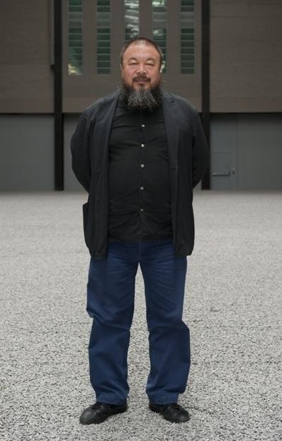Ai Weiwei in his field of porcelain sunflower seeds. The seed, says the artist, symbolises the Chinese people
