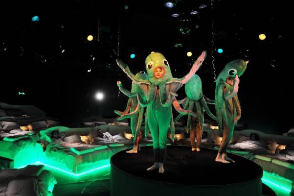 Octopuses perform a stately pas de quatre, tentacles aloft.