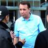 Mikhail Pletnev is questioned by a Thai police officer in front of the muscian's Pattaya residence