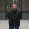 Ai Weiwei in his field of porcelain sunflower seeds. The seed, says the artist, symbolises the Chinese people