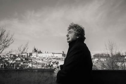 Semyon Bychkov on the banks of the River Vltava with Prague's Hradčany castle district behind