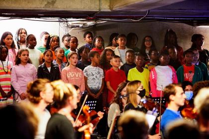 Note-perfect from memory, Peckham schoolchildren waiting for their entry