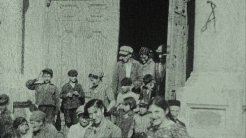 People of Nasielsk come out of the synagogue to see the man with the movie camera