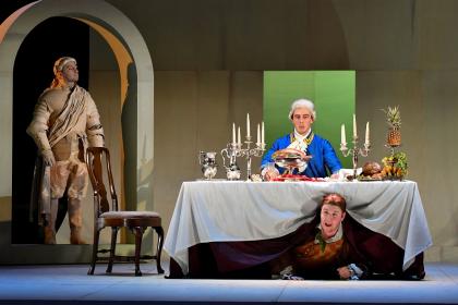 The statue of the Commendatore (David Fraser) comes to dinner with Don Giovanni (Marcus Swietlicki) as Pasquariello (Daniel Barrett) cowers