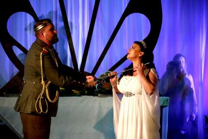 Brian Smith Walters as a threatening Menelaus and Justine Viani as Helen in Act One