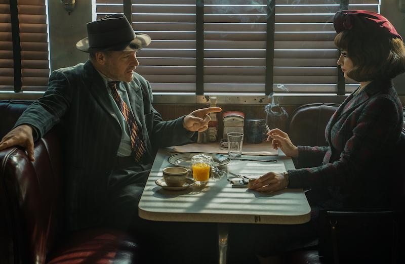 Peter Sarsgaard and Penelope Cruz, as a detective and his assistant, talking to each other in a diner