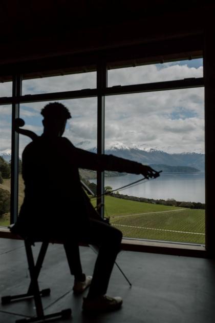 cellist in front of mountains