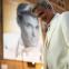 Mirror, mirror: George Clooney as Jay Kelly, with a poster of his younger self
