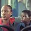 Lokita (Joely Mbundu) and Tori (Pablo Schils) on their quest for a safe home