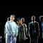 Antigone (Zainab Hasan) after her arrest, with members of the ensemble